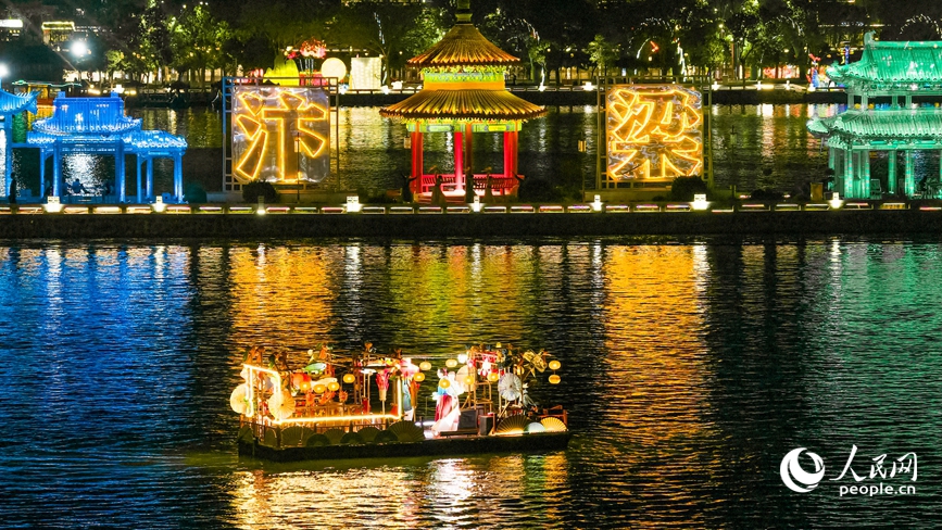 乘着晚风登临汴河游船，河岸的亭台楼阁、银丝古建在华灯映照下愈显古朴典雅。人民网记者 王佩摄